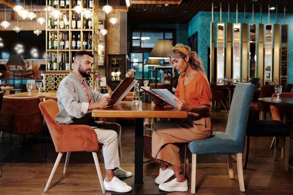 Man andn woman looking at menus in a restaurant